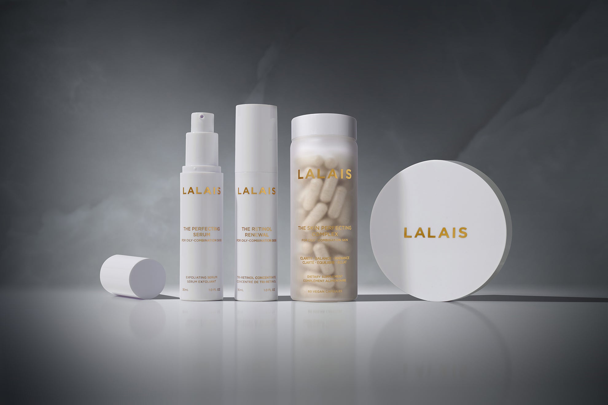 Four Lalais skincare items on a grey background: Serum, Retinol, Complex, and Blotting Compact.