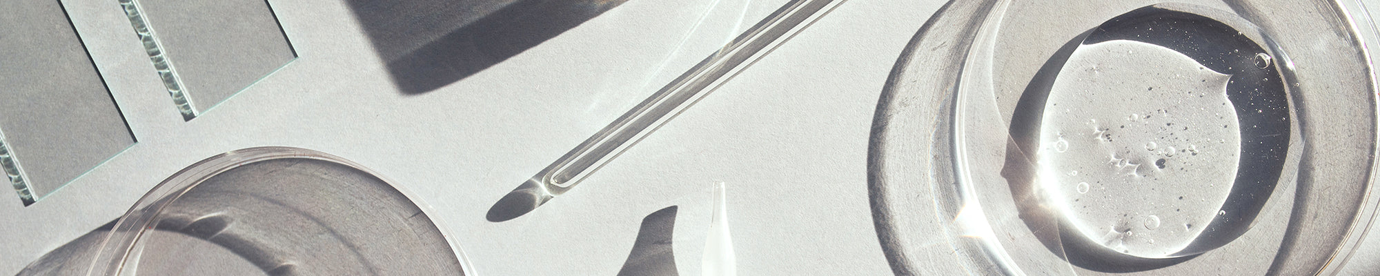 clean clear glass lab items on a white background