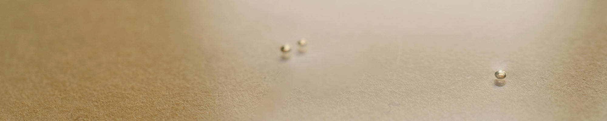 golden colored background with three small floating bubbles