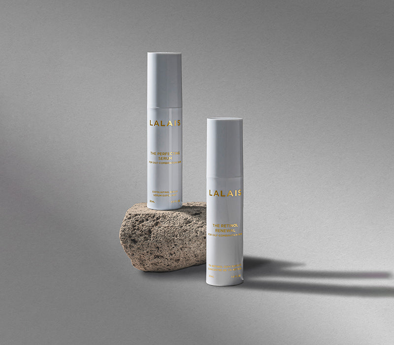 Lalais Perfecting Serum on a rock and Retinol Renewal next to it with a grey background